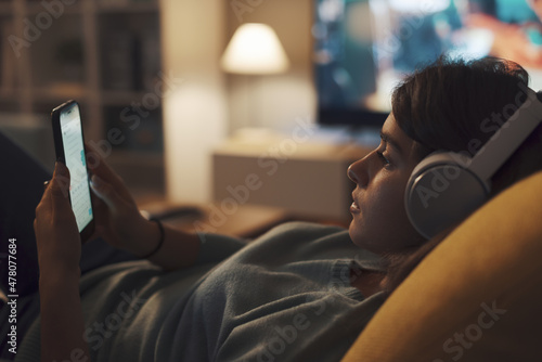 Teenager relaxing on the sofa and connecting online
