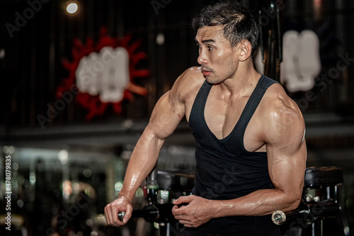 Asian men wear black workout in fitness center © Sommart Sopon