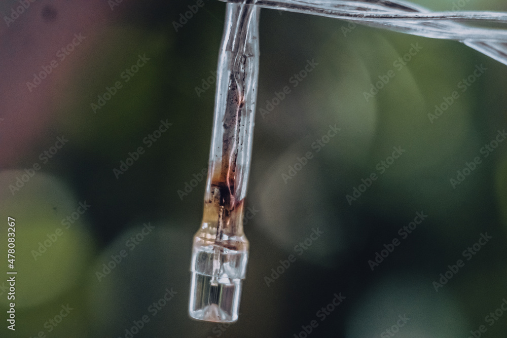 Macro Close-up old small burned out white pale plastic Light emitting diode LED Strip lamp of electric garland. Blur background. Outdoor object technologies. Burnt wire spoiled product defective Macro Close-up old small burned out white pale plastic Light emitting diode LED Strip lamp of electric garland. Blur background. Outdoor object technologies. Burnt wire spoiled product defective