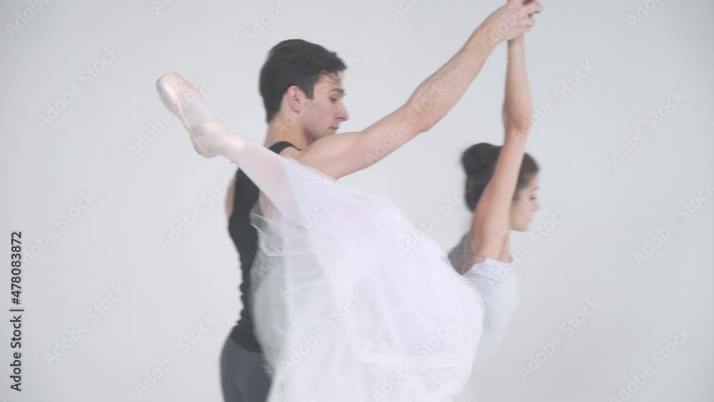 Dramatic couple of classical ballet dancers rehearsing a dance, romantic dance of ballet dancers, a young couple engaged in choreography.