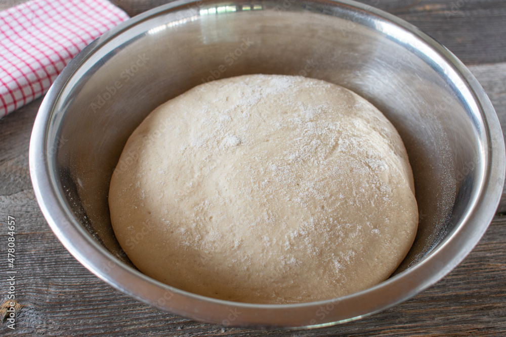 Risen yeast dough in a bowl Risen yeast dough in a bowl