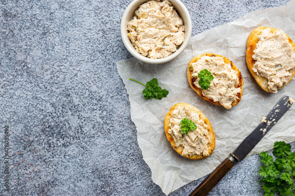 Sandwiches with salmon pate and baguette, fish bruschetta, top view. Rustic homemade Italian cuisine. Sandwiches with salmon pate and baguette, fish bruschetta, top view. Rustic homemade Italian cuisine.