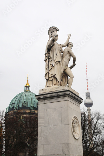 Statues at Schloss bridge in Berlin, with the view to TV tower and Berlin cathedral, Germany photo