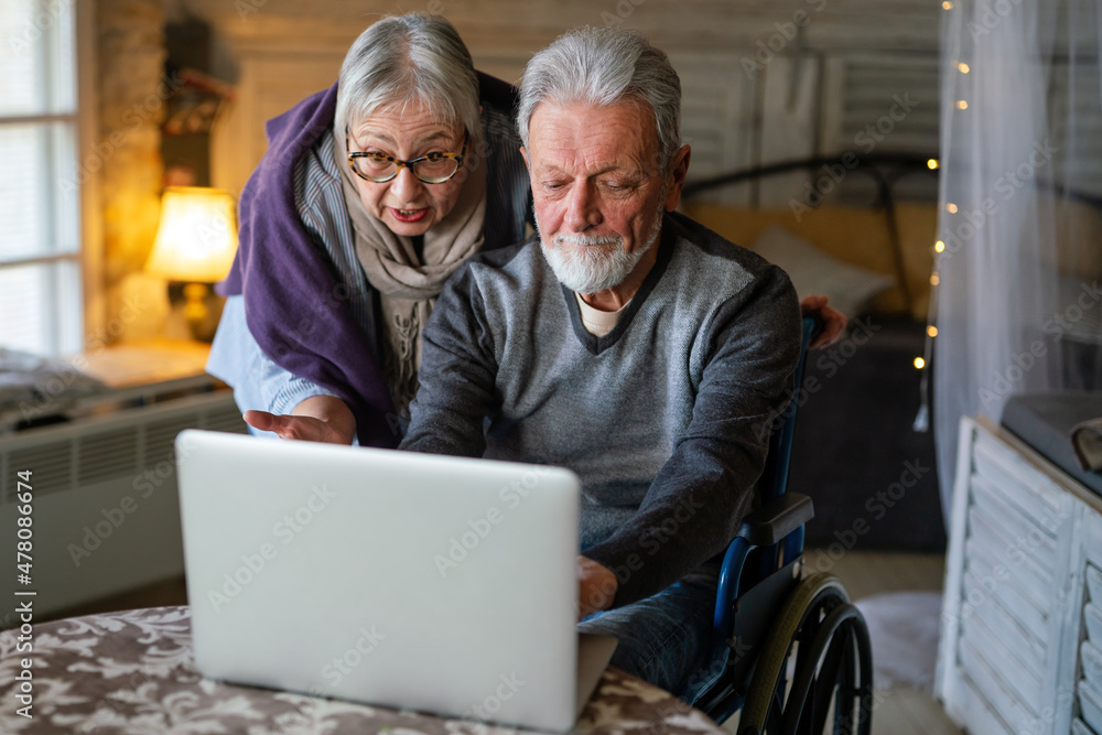Happy senior couple using notebook at home and having fun together. Technology people concept Happy senior couple using notebook at home and having fun together. Technology people concept