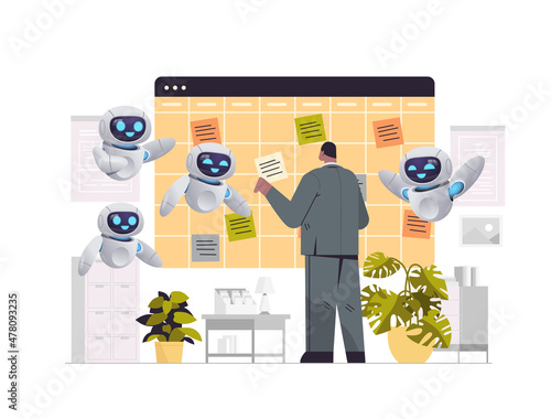 businessman with robots assistants planning day scheduling appointment agenda meeting plan time management