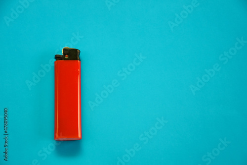 Obraz na plátně Gas lighter of red color on a blue background