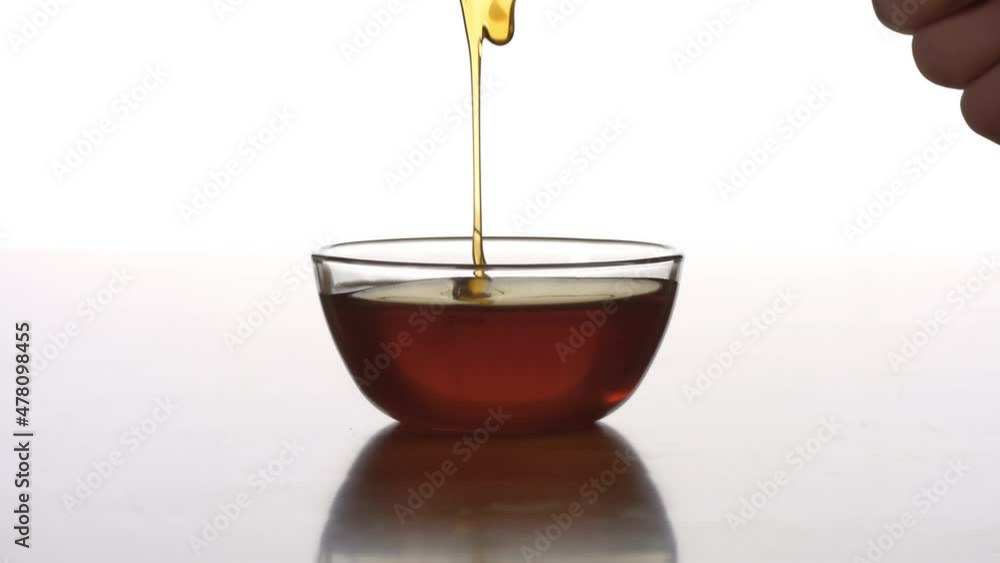 Honey dripping from honey dipper on white background
Honey dripping from honey dipper on white background
