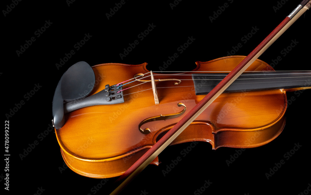 Violin with bow on strings isolated on black background. Violin with bow on strings isolated on black background.