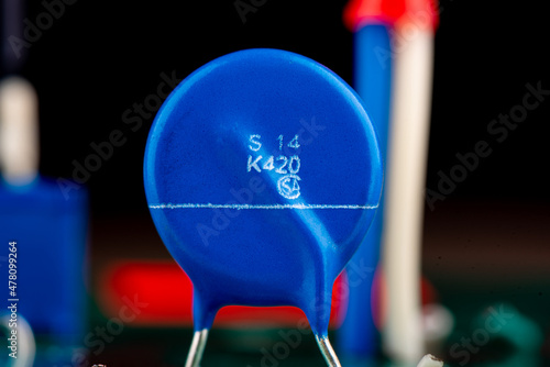 Close up of blue varistor electronic circuit board element. photo
