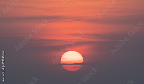 The Sun with sunset sky. Abstract nature background. Dramatic blue with orange colorful clouds in twilight time. © tampatra