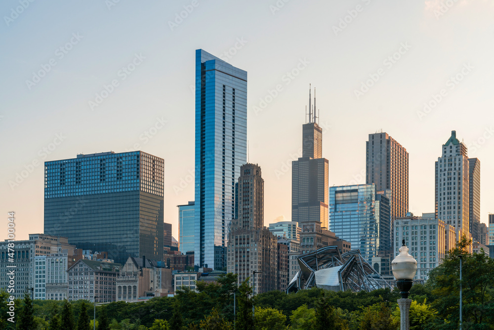 Chicago skyline panorama from Park at sunset, golden hour. Chicago, Illinois, USA. Skyscrapers of financial district, a vibrant business neighborhood.
