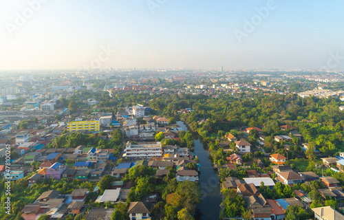 Aerial view of Bang Khun Thian Canal with nature trees, Wutthakat district, Bangkok City, Thailand in urban city in Asia. Residential houses, buildings at noon.