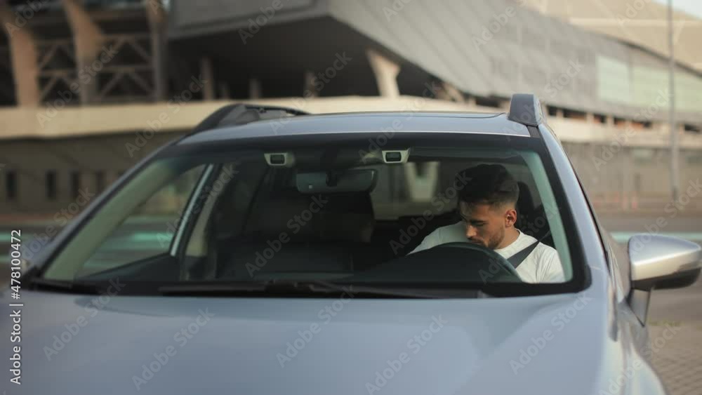 A man is going to the car. He is opening the door and sitting in the driver's seat. He is pinching his seat belt and putting his hands on the steering wheel. 4K 50fps A man is going to the car. He is opening the door and sitting in the driver's seat. He is pinching his seat belt and putting his hands on the steering wheel. 4K 50fps