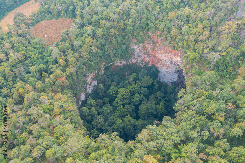 Aerial top view of Spirit Well Cave, Pang Mapha District, Mae Hong Son, Thailand. Tourist attraction landmark. Nature landscape background. Aerial top view of Spirit Well Cave, Pang Mapha District, Mae Hong Son, Thailand. Tourist attraction landmark. Nature landscape background.