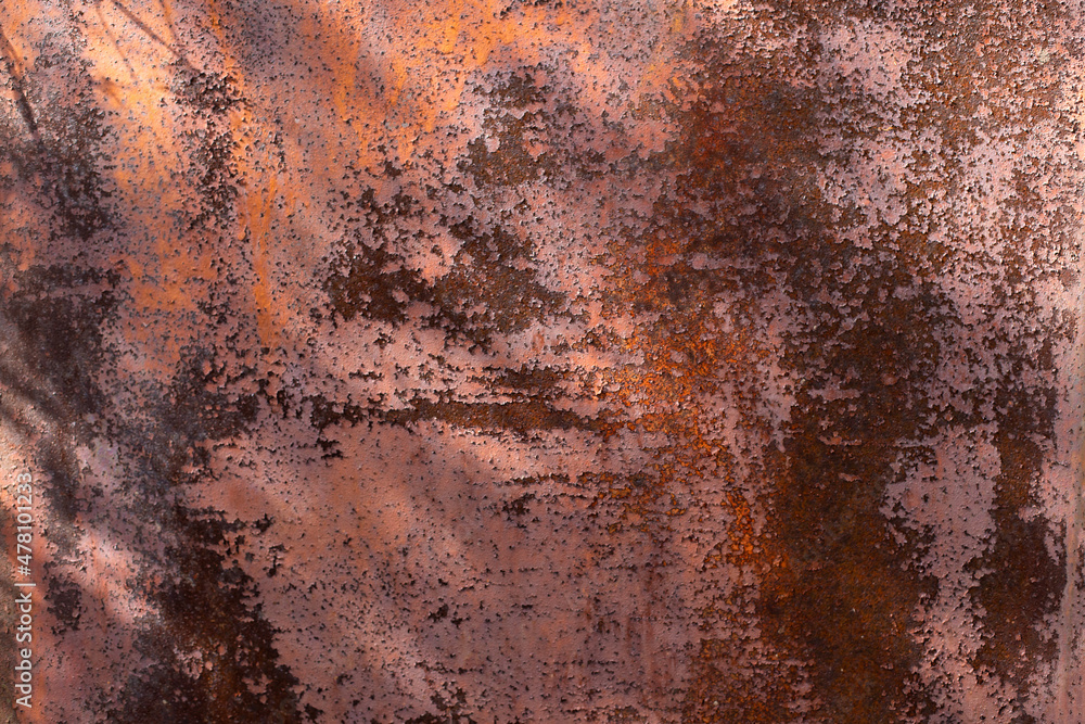 Rusty metal background. Red metal texture with rust. Rust stains a lot and Sun rays, noisy background. Rusty metal background. Red metal texture with rust. Rust stains a lot and Sun rays, noisy background.