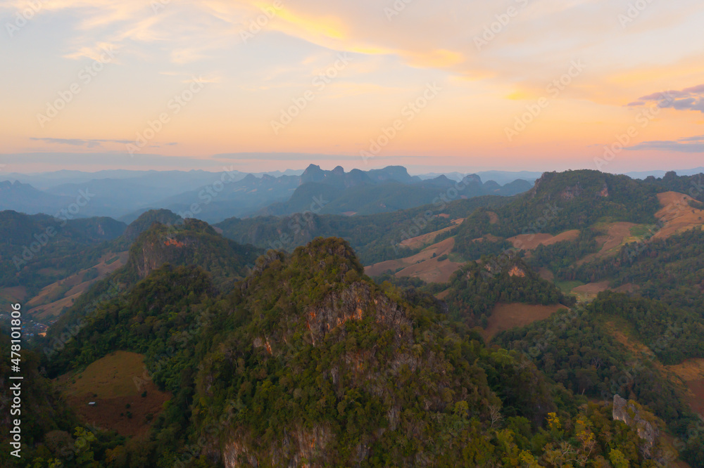Naklejka premium Aerial top view of forest trees and green mountain hills. Nature landscape background, Thailand.