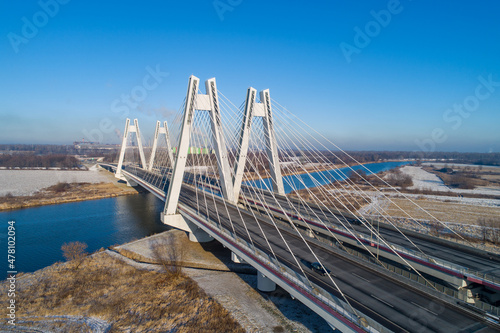 New modern Macharski double cable-stayed three-lane suspension bridge over Vistula River in Krakow, Poland. Aerial view in winter. Part of the ring road around Krakow