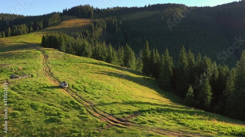 SUV car goes off-road upwards. Auto moving on the mountain road. Location place Carpathian mountains, Ukraine, Europe. 