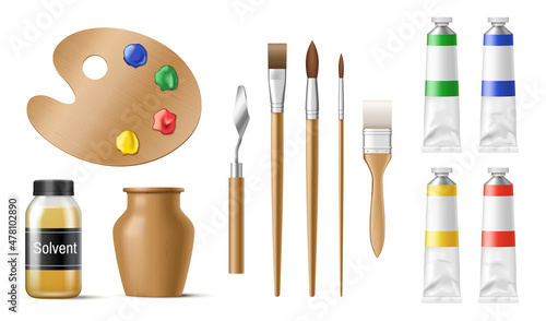 Painter tools set with paintbrushes, acrylic paint in tubes, palette, pallet knife and paint brush