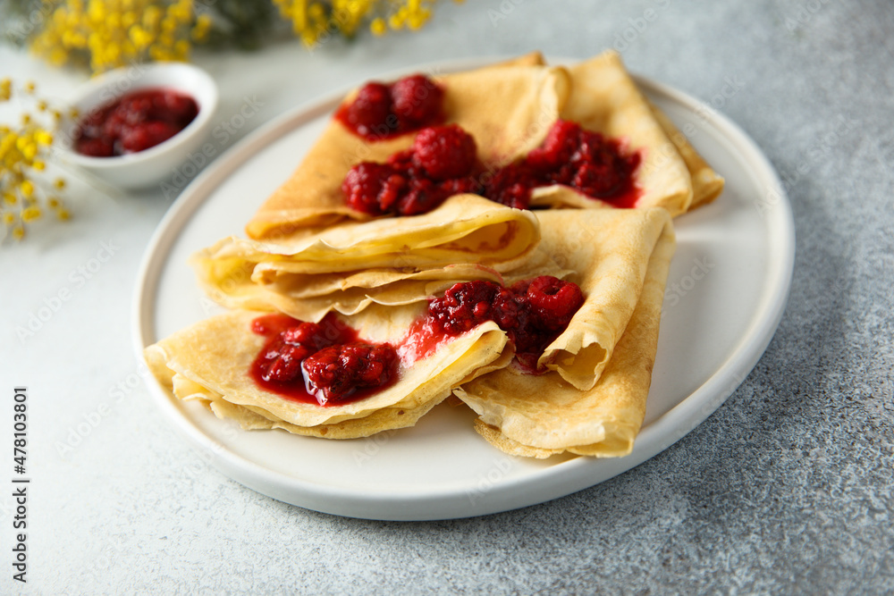 Homemade crepes with raspberry sauce