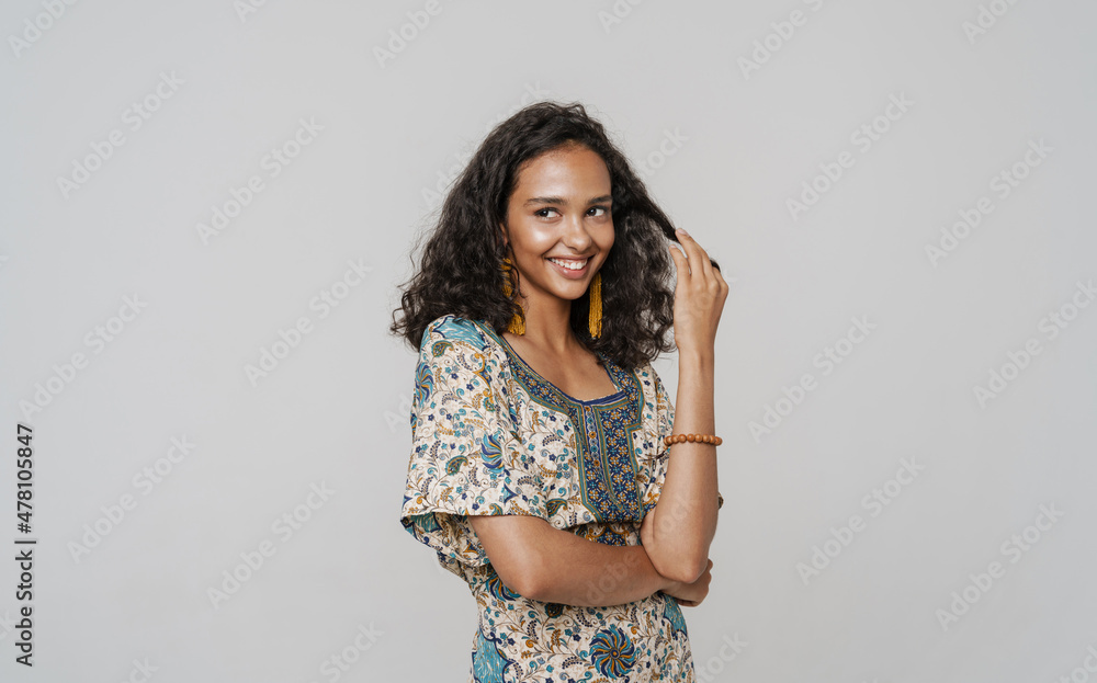 Young south asian woman wearing dress laughing and looking aside Young south asian woman wearing dress laughing and looking aside