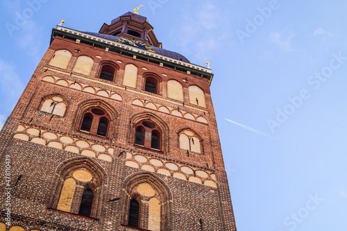 Airplane on the background of an old tower in old Riga2