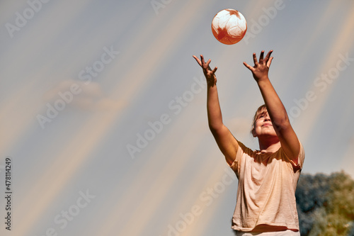 A girl is playing with a ball . A child throws a ball .