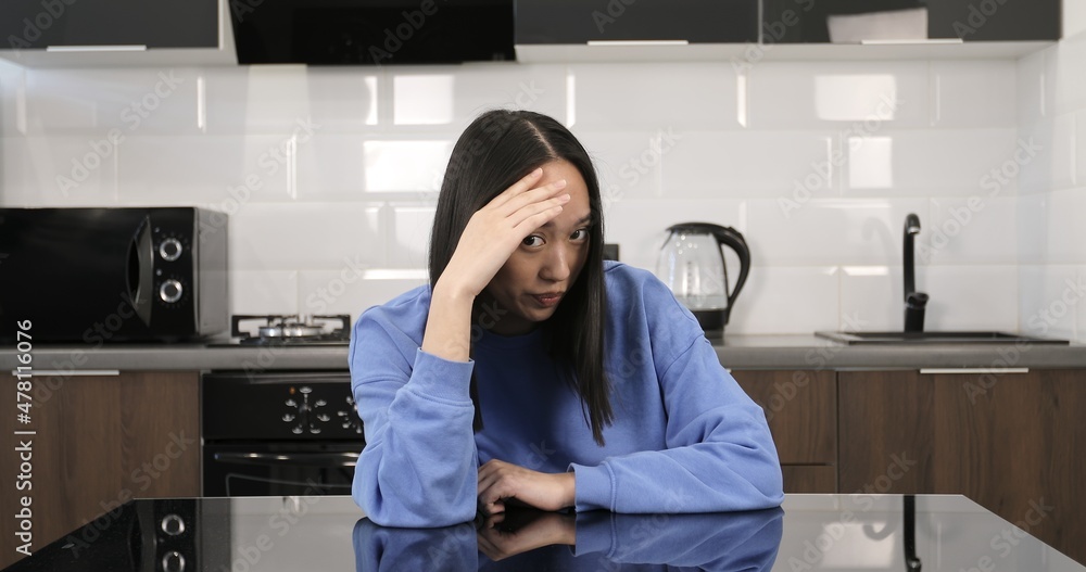 Young Asian woman is ashamed at the camera. Pretty girl hides her eyes. Young Asian woman is ashamed at the camera. Pretty girl hides her eyes.