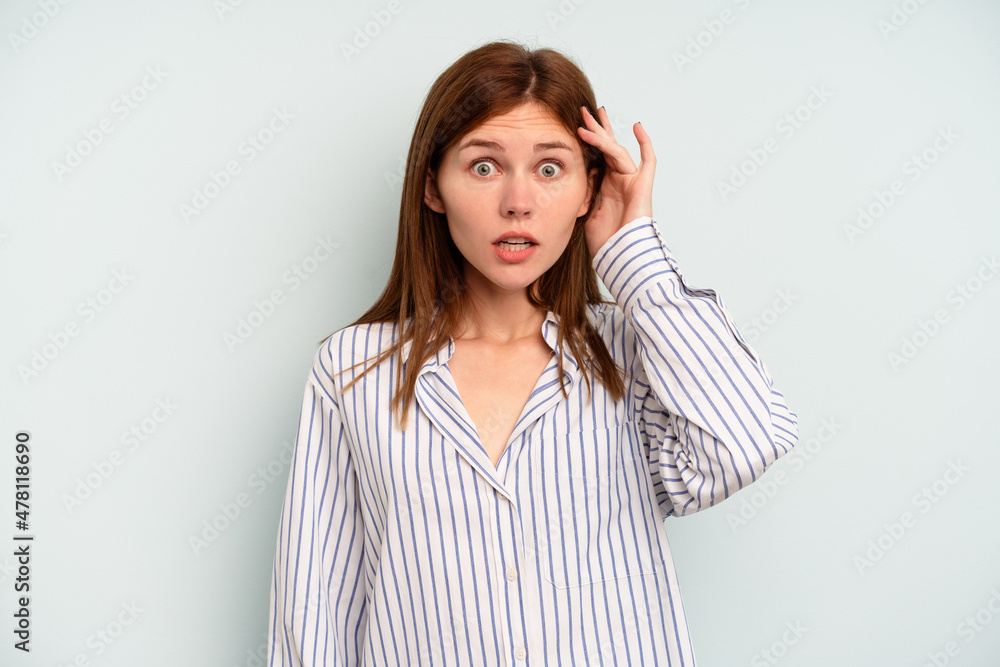 Young English woman isolated on blue background being shocked, she has remembered important meeting. Young English woman isolated on blue background being shocked, she has remembered important meeting.
