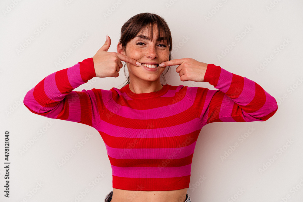 Young Argentinian woman isolated on white background smiles, pointing fingers at mouth. Young Argentinian woman isolated on white background smiles, pointing fingers at mouth.