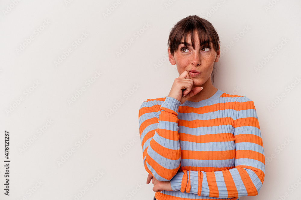 Young Argentinian woman isolated on white background relaxed thinking about something looking at a copy space. Young Argentinian woman isolated on white background relaxed thinking about something looking at a copy space.