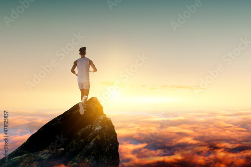 Man running against sunset sky background