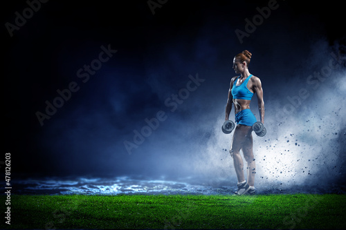 Young beautiful girl doing exercise against dark background