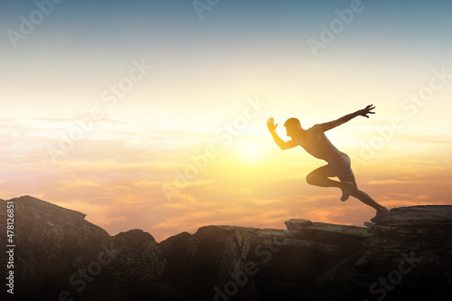 Man running against sunset sky background