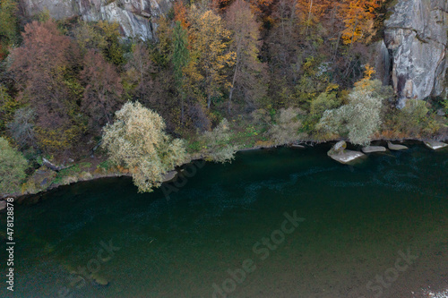 Fototapeta Naklejka Na Ścianę i Meble -  River rapids near mountain foothill with terracotta forests
