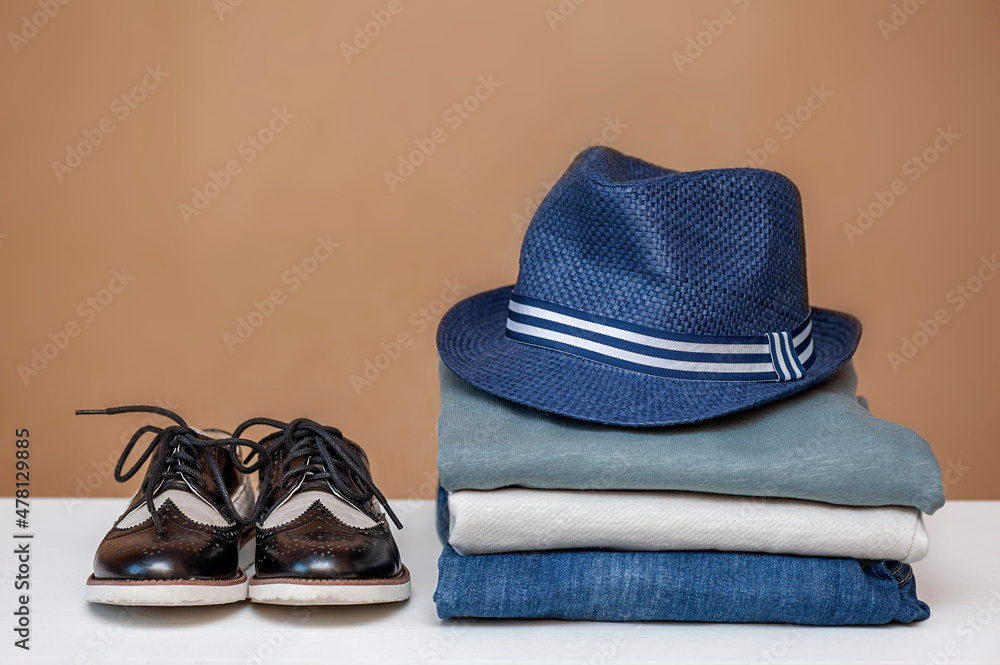Clothing concept. Stack of clothes and shoes blue navy tone Clothing concept. Stack of clothes and shoes blue navy tone