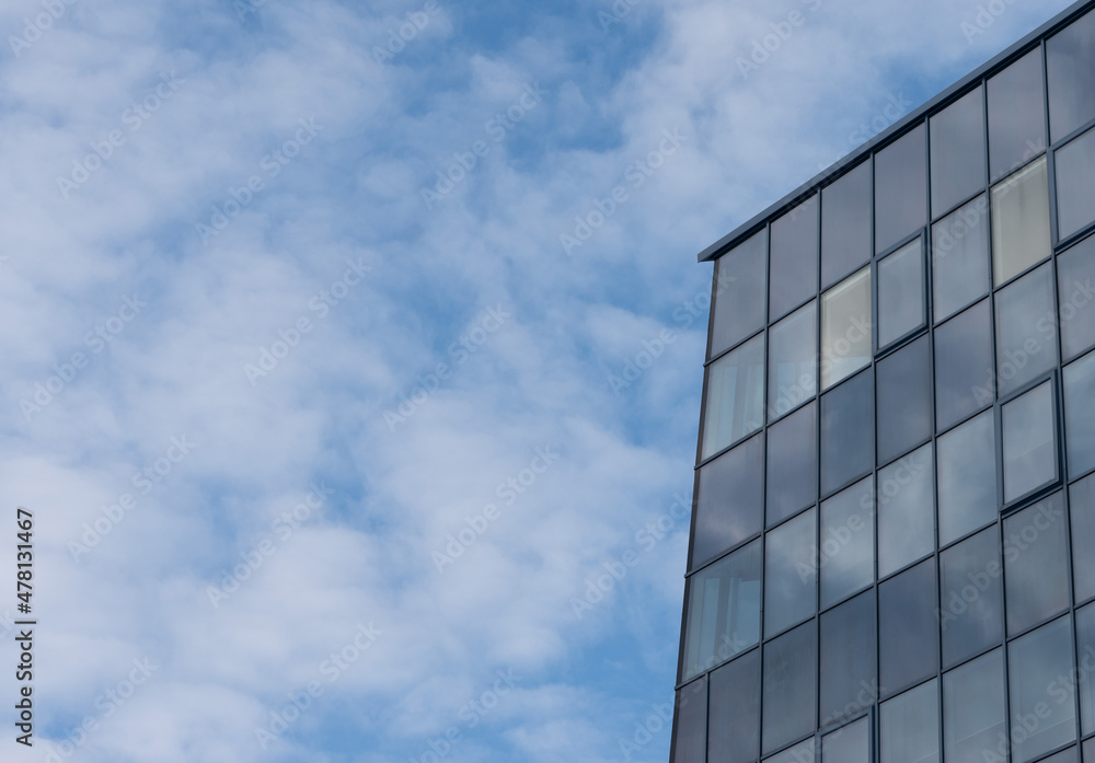 Element of a business center building made of glass on a background of blue clear sky. Element of a business center building made of glass on a background of blue clear sky.