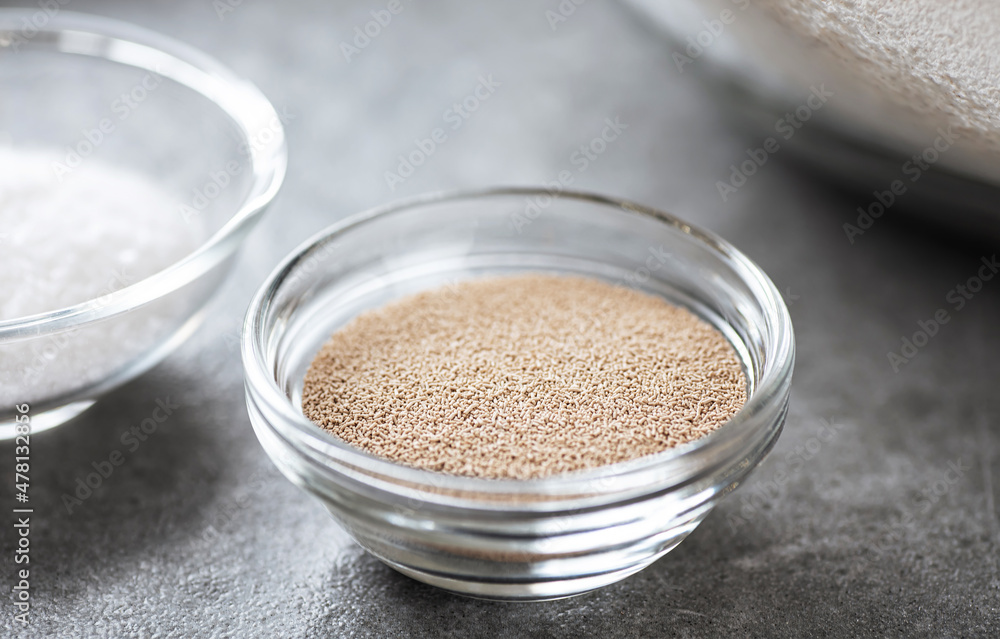 Glass bowl with yeast for baking. Glass bowl with yeast for baking.