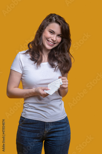 Joyous cute woman posing for the camera before mailing