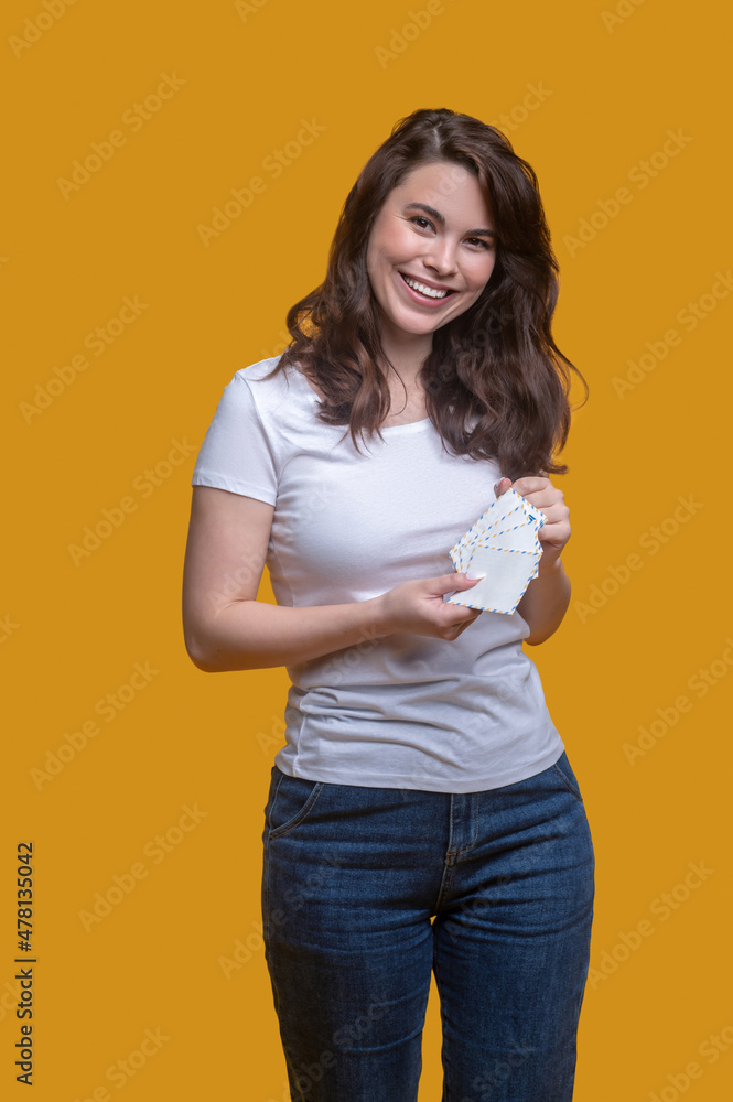 Joyful woman posing for the camera before sending her mail Joyful woman posing for the camera before sending her mail