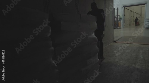 Yerevan, Armenia - September, 2021. Loader unload pallets with boxes from a trailer truck. Close up. Slow Motion 100fps