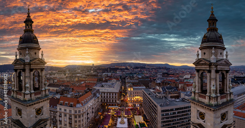 Panoramic view from the Saint Stephand Basilica to the skyline of Budapest, Hungary, with a christmas market at the square during a colorful winter sunset