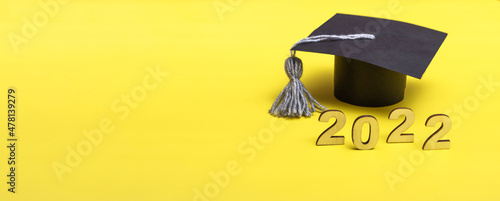 Gift box in the form of a graduation cap. 2022 release concept on yellow background copy space. Banner