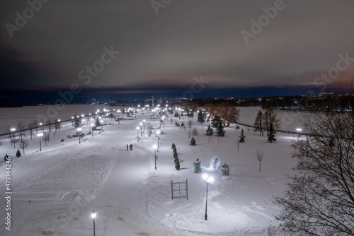 Strelka's place in Yaroslavl - a park and a stele in it. People walking in the distance in Yaroslavl (Gold ring of ancient russian towns arounв Moscow) © Marat Lala