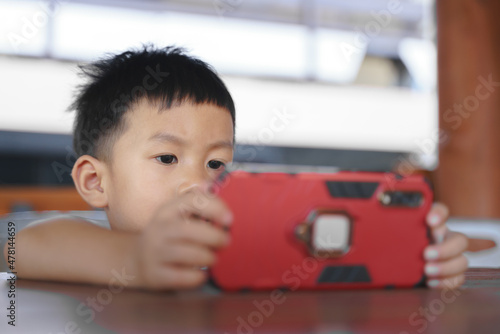 Asian boy about 3 year and 10 months addict and keep using mobile phone