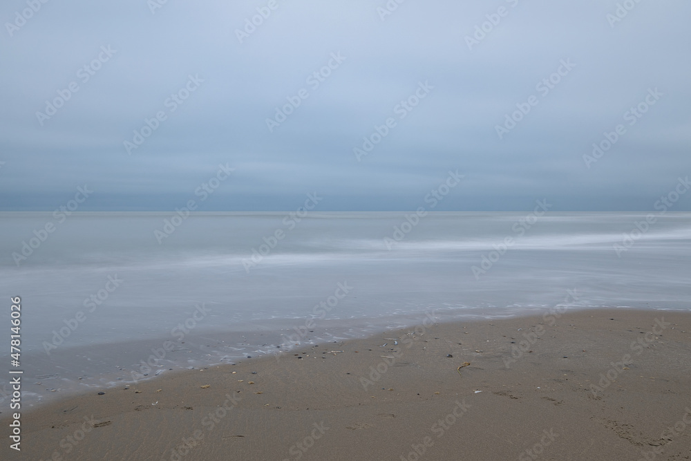 Horizontal minimalistic view on the sea on a cloudy day. Abstract seascape background and beach scene with soft blur and copy space Horizontal minimalistic view on the sea on a cloudy day. Abstract seascape background and beach scene with soft blur and copy space