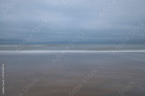 Fototapeta Naklejka Na Ścianę i Meble -  Horizontal minimalistic view on the sea on a cloudy day. Abstract seascape background and beach scene with soft blur and copy space
