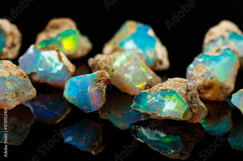 Schilderij op canvas macro mineral stone rare and beautiful opals on a black background