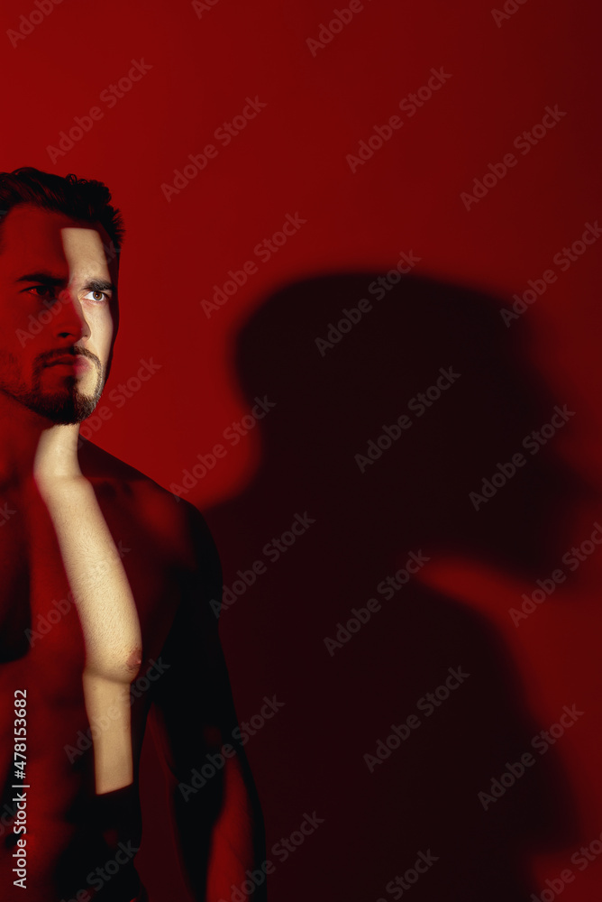 Male model appearance. His torso is bare. He looks away Male model appearance. His torso is bare. He looks away