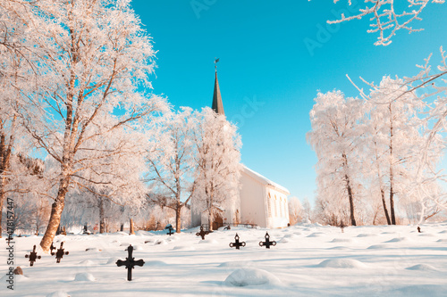 Christian church with cemetery in the snow in the arctic circle in Norway photo
